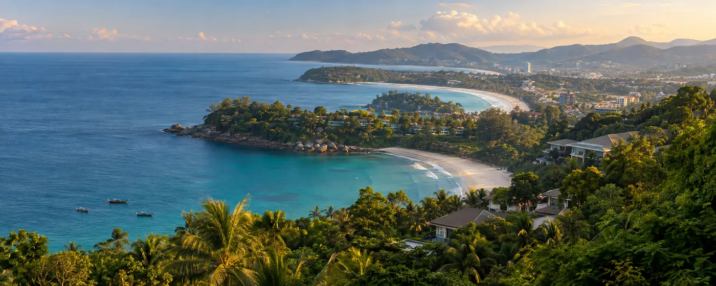 A Phuket bay of turquoise water and white sand between green headlands