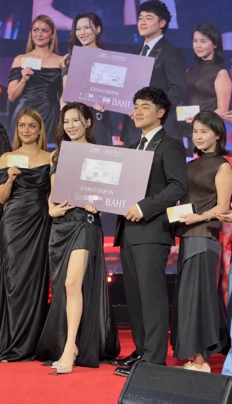 A.D. advisors on stage holding their cash-coupon prizes