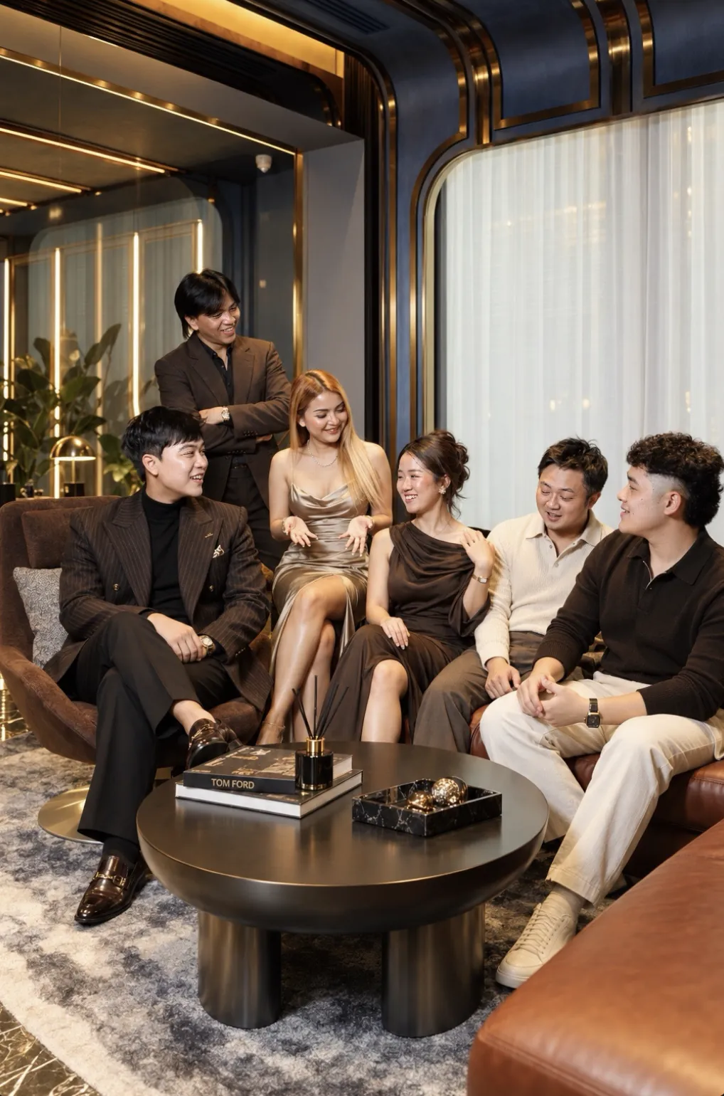 The A.D. team together in a lounge, seated around a low table
