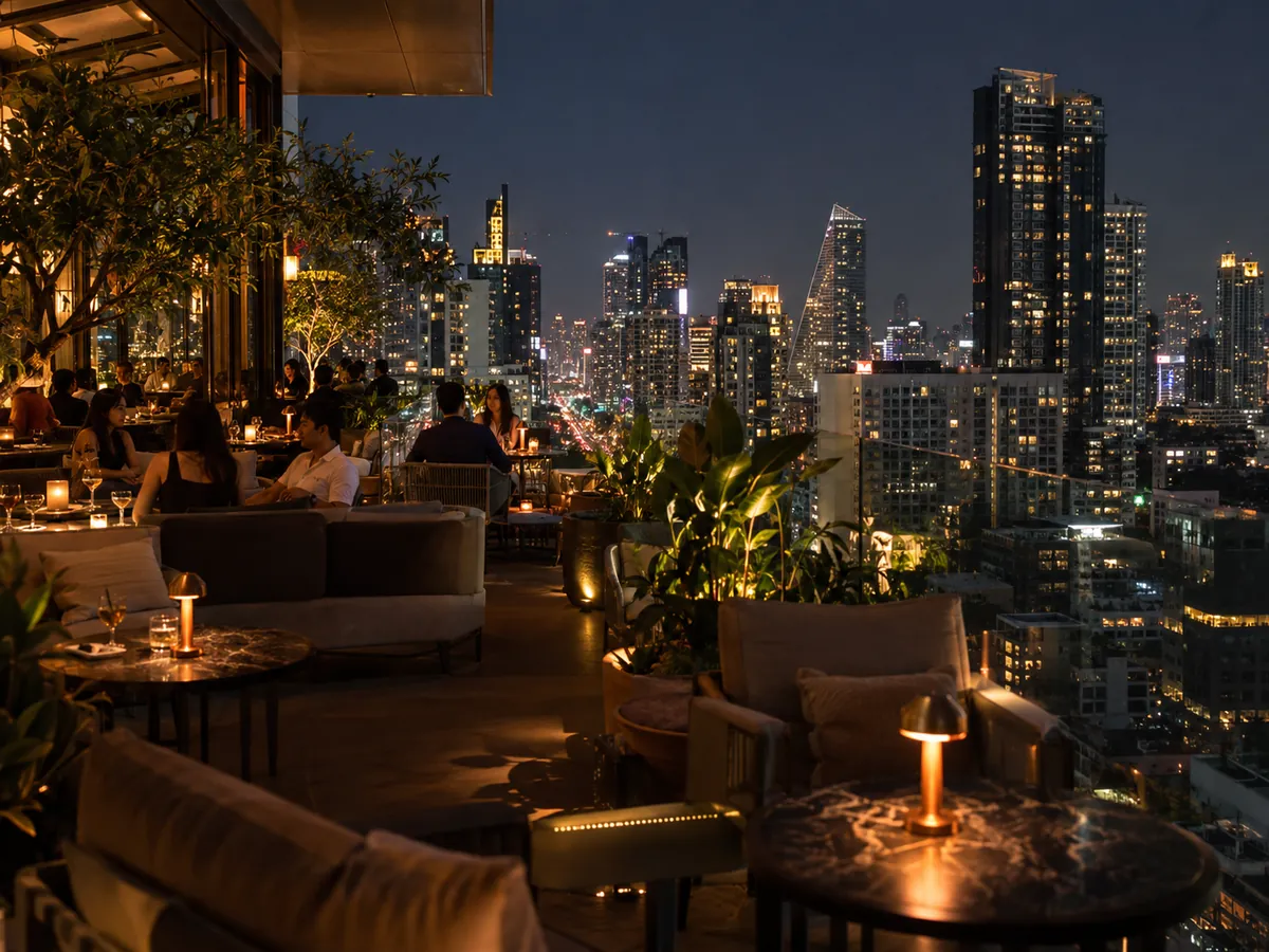 A rooftop terrace at night above the towers of Sukhumvit