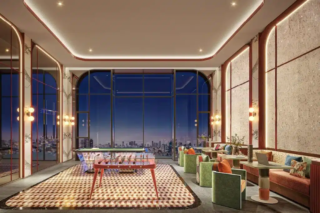 Developer rendering of a shared lounge with a games table and city view