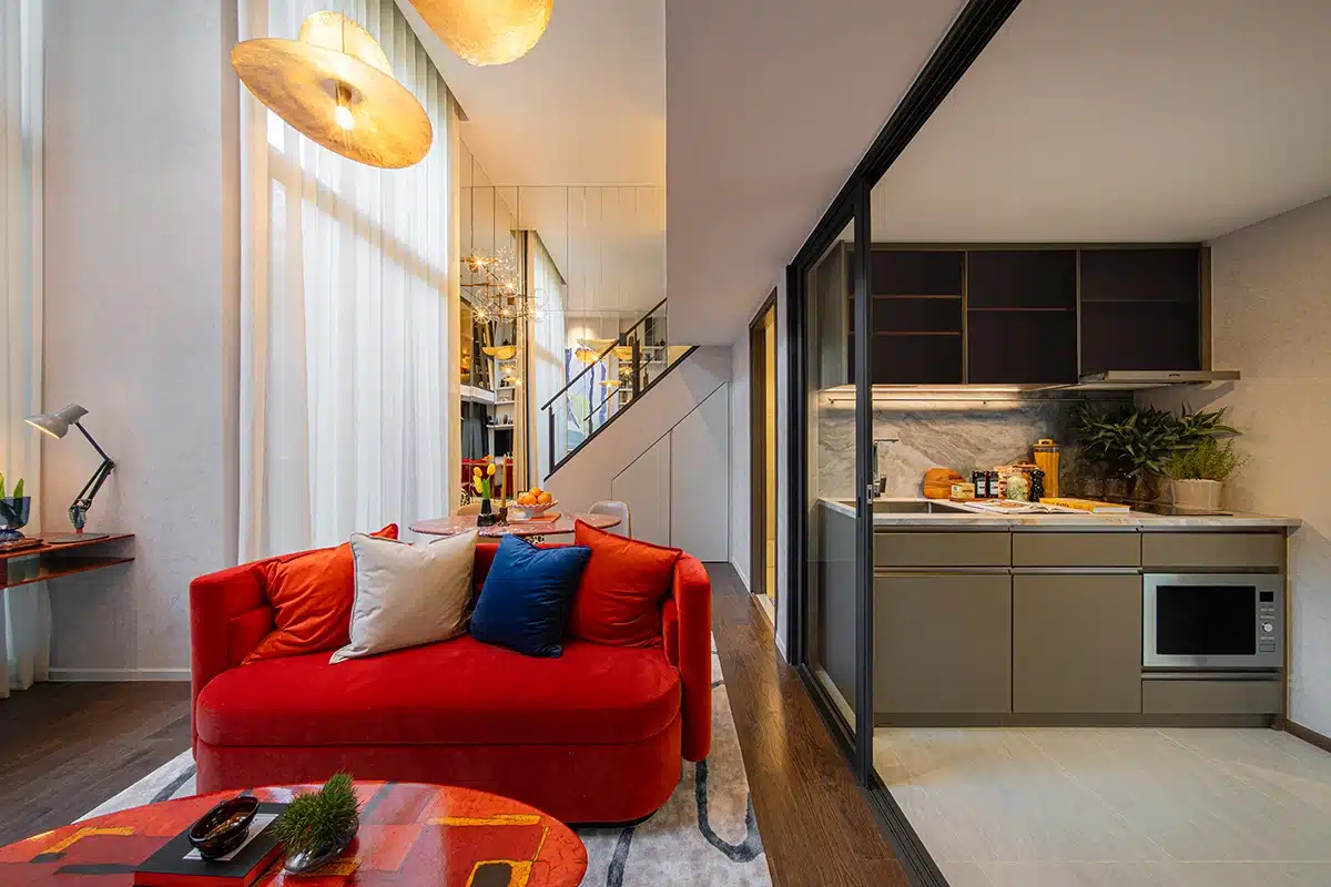 High-ceilinged living room, staircase and kitchen in a SHUSH Ratchathewi show unit